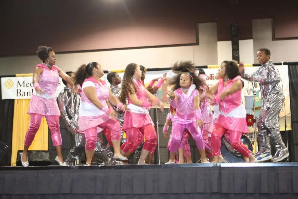 children dressed in pink dancing on stage